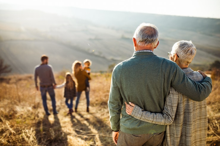 Embraced grandparents on walk with family outside
